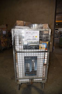 a metal cart with a stove inside of it in a warehouse