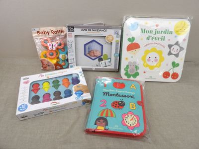 a lot of baby toys and books on the bed