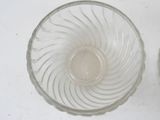 a glass bowl and a glass cup on a table