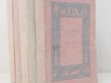 three books are stacked on top of each other on a white surface
