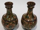 two vases sitting next to each other on a table