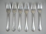six forks and six spoons arranged in a row on a table