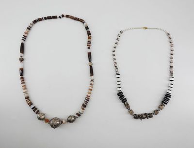 two necklaces with black, white and brown beads on a white background