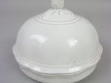 a white bowl with a lid on a table