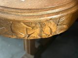 a wooden table with a carved fish design on it