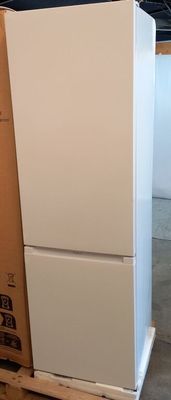 a white refrigerator sitting on top of a pallet in a warehouse