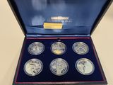 a set of six silver coins in a blue box