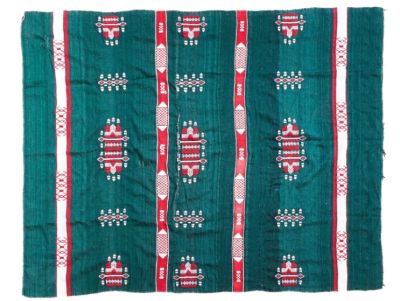 a green rug with red and white designs on it