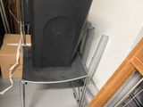a chair that is sitting in a room with a trash can on it