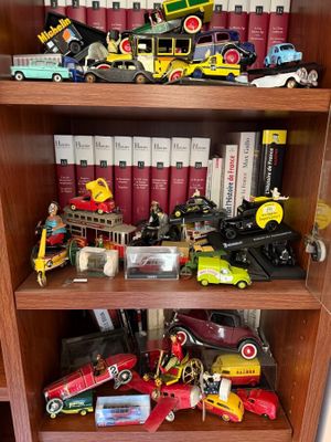 a book shelf filled with toy cars and books