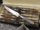 a box with a knife and several knives inside of it