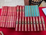 several books are stacked on a table with a red table cloth