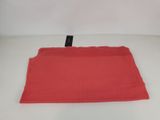 a close up of a red shirt on a white surface