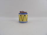 a small yellow and blue drum on a white surface