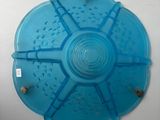 a blue plastic plate with holes in it on the wall