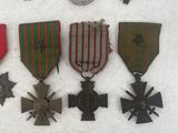 many medals and medals on display on a white surface