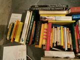 a pile of books on the floor next to a pile of books