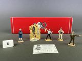the figurines are in a box with a red box behind them