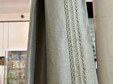 a curtain hanging in a room with a wooden floor