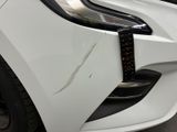 a close up of the front bumper of a white car