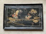 painting on the wall of a room with a bird and other items
