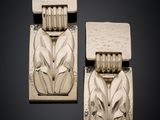 pair of art deco earrings with a stylized design on the front