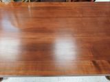 an image of a wooden table with metal legs