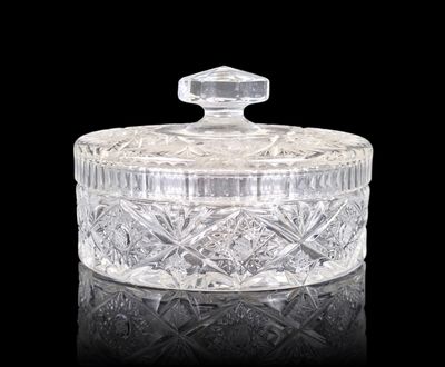 an image of a clear glass jar with a lid on a black surface