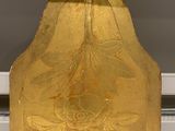 a gold plate with a flower design on it on a table