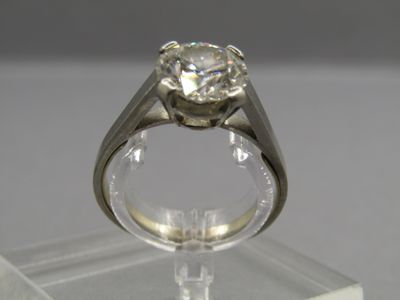 an image of a diamond ring on a clear stand