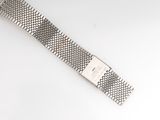 a close up of a watch bracelet on a white surface