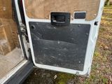 a white van with a door open on the side of the road