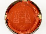 a red and gold plate with a picture of a castle on it