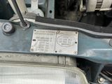 a close up of a metal plate on a car ' s engine