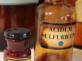 a bottle of liquid next to a bottle of medicine