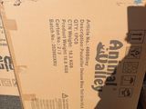 cardboard boxes stacked on top of each other in a parking lot