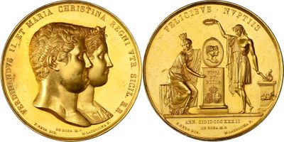 a close up of a gold coin with an image of a woman and a man