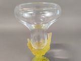 a glass vase with a yellow flower inside of it