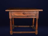 an old wooden table with a drawer on top of it