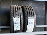 two tires are stacked on a shelf in a garage
