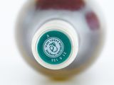 a close up of a bottle of wine on a white surface