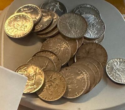 a plate of coins sitting on a table next to a napkin