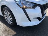the front end of a white car with a black stripe on it