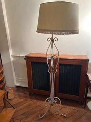 a lamp that is sitting on a stand in a room