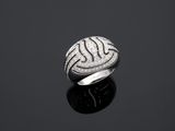 une image représentant une bague en argent posée sur une surface noire