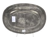 an old metal tray with a tag on it sitting on a stand