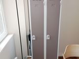 a chair and a table in a room with two lockers