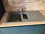 a kitchen sink with two faucets on the counter