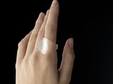 a woman ' s hand with a band on it