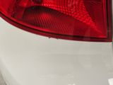 a close up of a car tail light on a white car